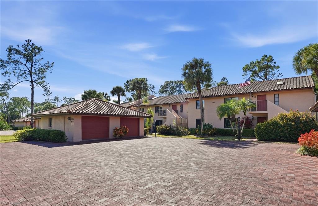 Private oversized single garage with pathway to residence, extra-large paver entrance, and loads of guest parking