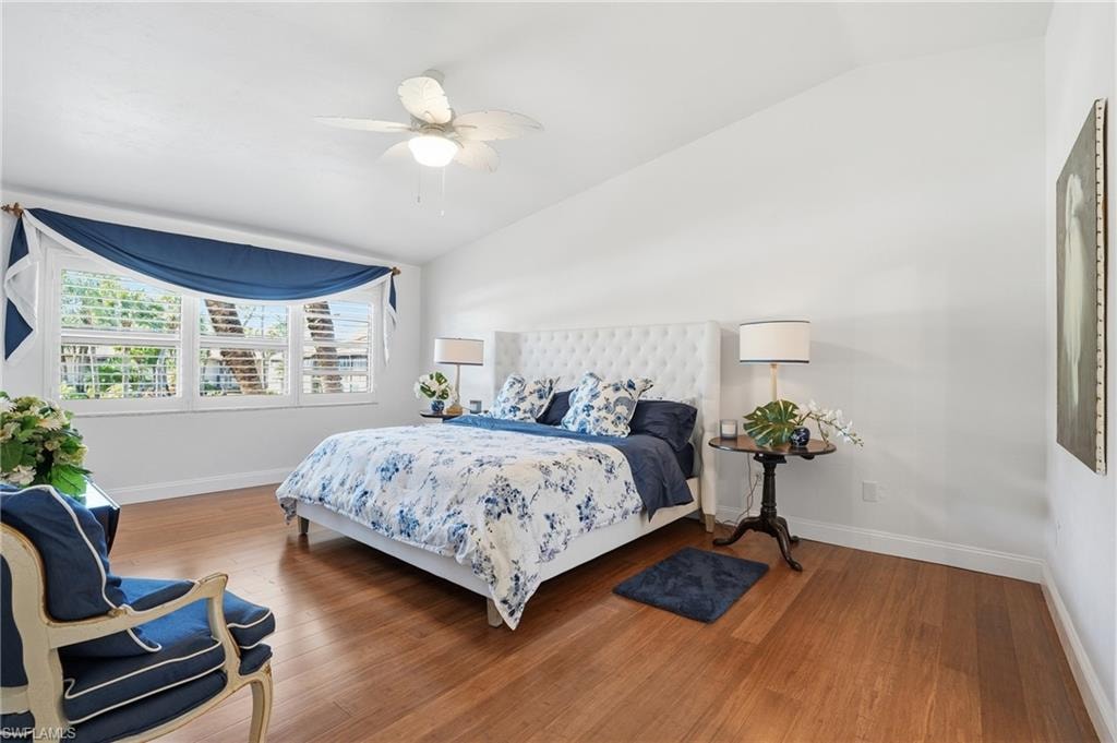 Primary Bedroom with lofted ceiling, plantation shutters, bamboo flooring and loads of light