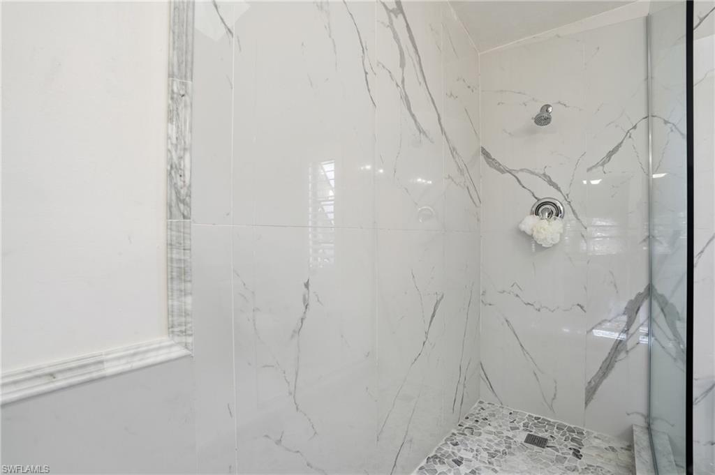 Primary bath beautifully remastered with custom marble and stone finishes