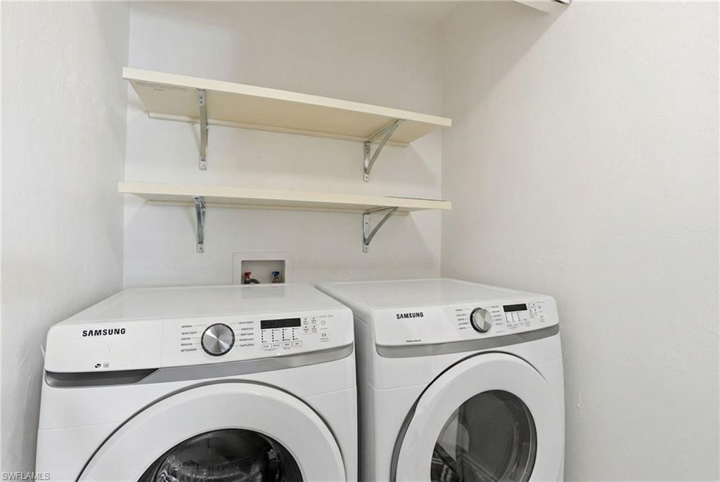 Laundry area with shelving and newer appliances