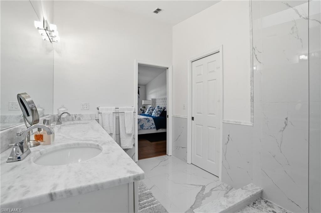Primary Ensuite bath with double vanity and marble finishes