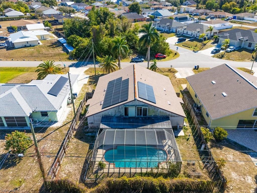Aerial perspective of suburban area with a pool area