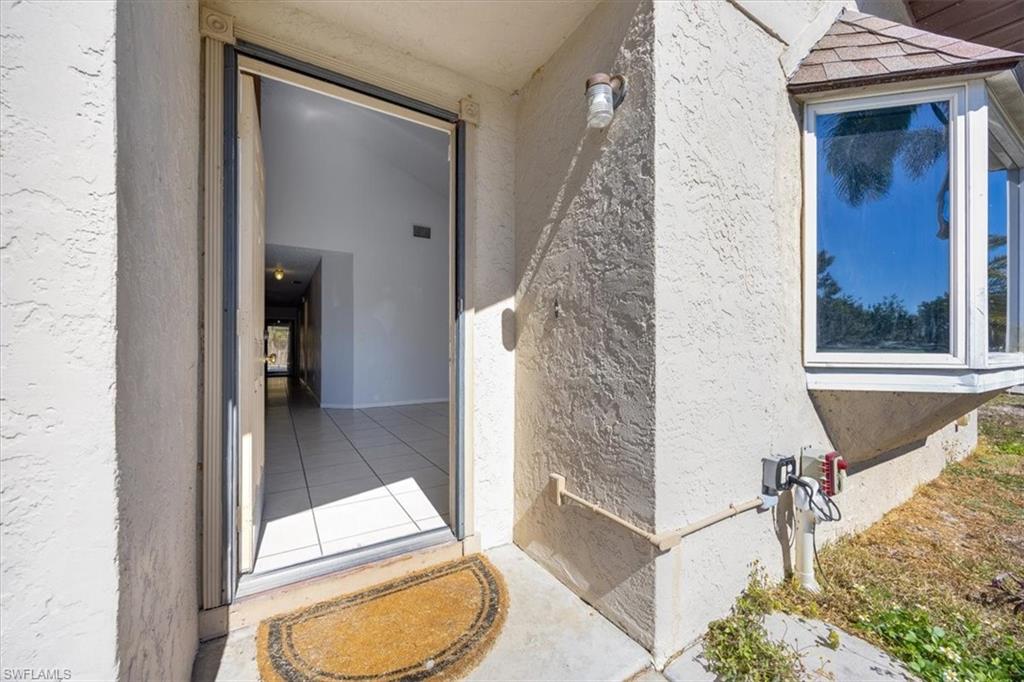 View of exterior entry with stucco siding