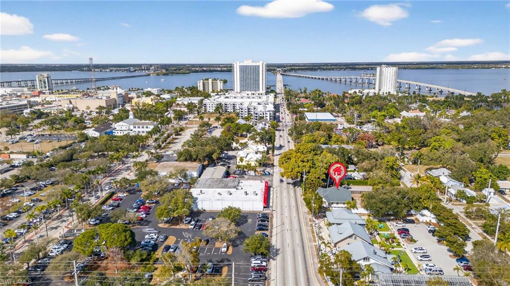 Aerial view of property and surrounding area featuring a notable bridge and a large body of water