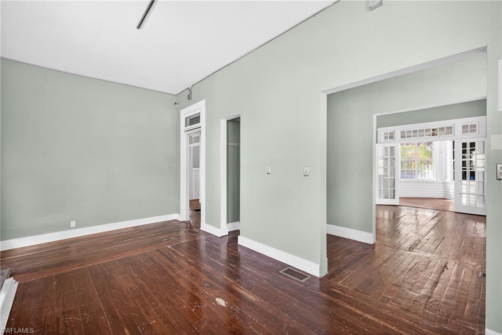 Empty room with dark wood-type flooring