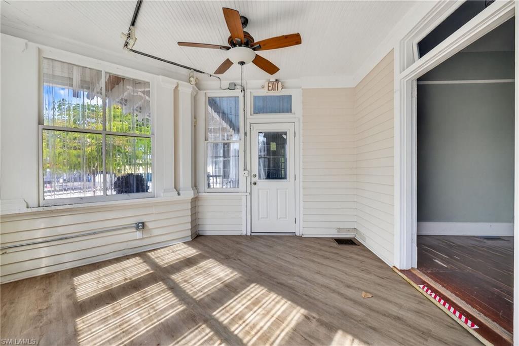 Unfurnished sunroom with a ceiling fan