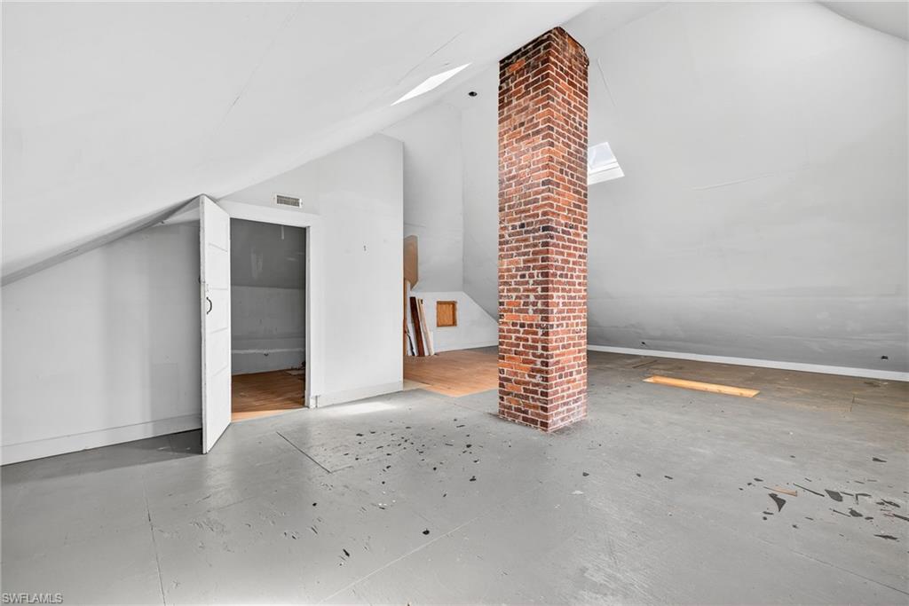Additional living space featuring vaulted ceiling