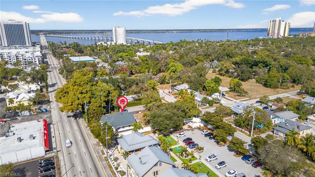 Aerial view of property and surrounding area featuring a large body of water and a notable bridge