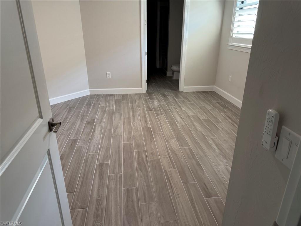 En suite bedroom with wood tiled floors