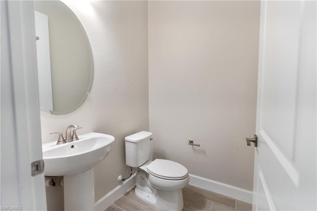 Powder room featuring  wood finish tile floors
