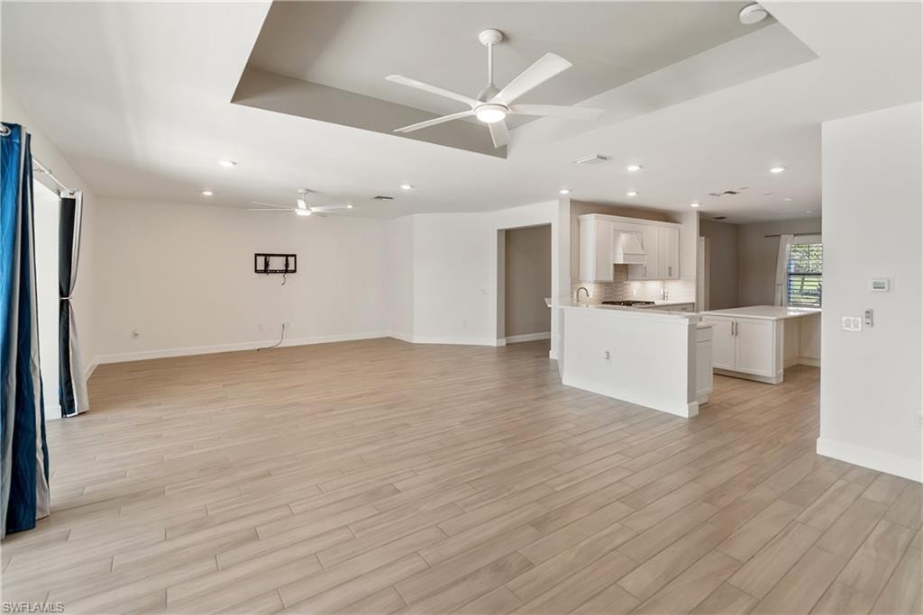 Living room with a ceiling fan and wood tiled floors