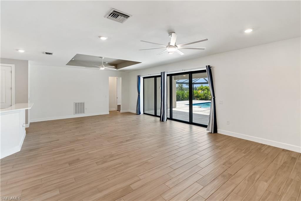Living room with a ceiling fan and wood tiled floors