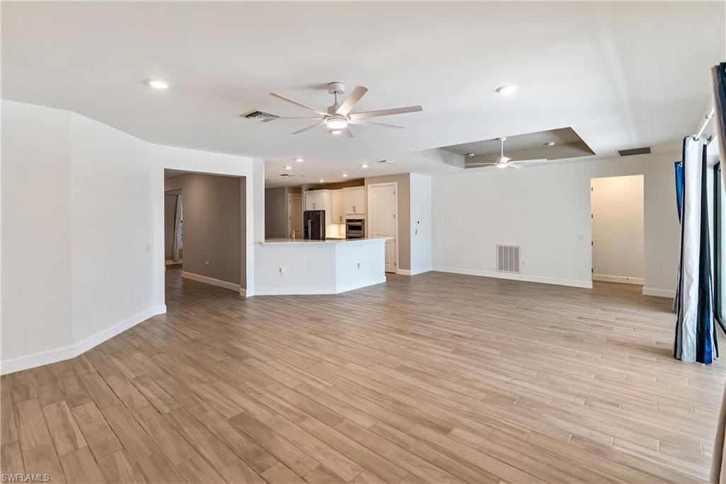 Living room with a ceiling fan and wood tiled floors
