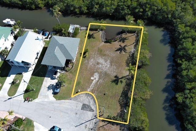 Aerial view of property's location featuring a nearby body of water and property parcel outlined