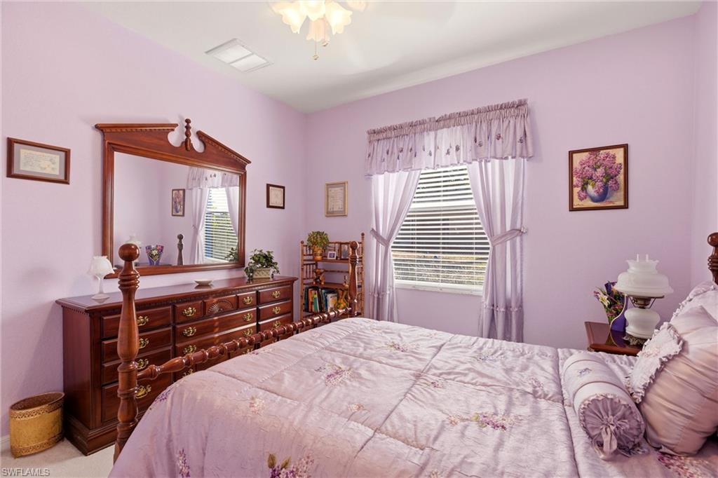 Bedroom with multiple windows and ceiling fan
