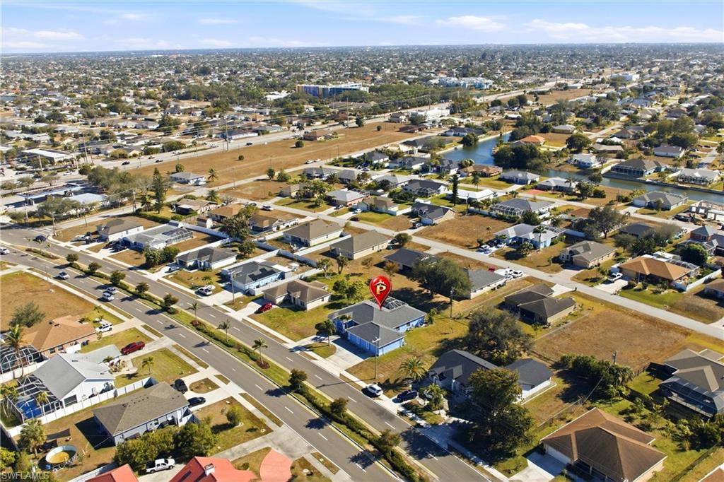 Aerial view of property's location with nearby suburban area