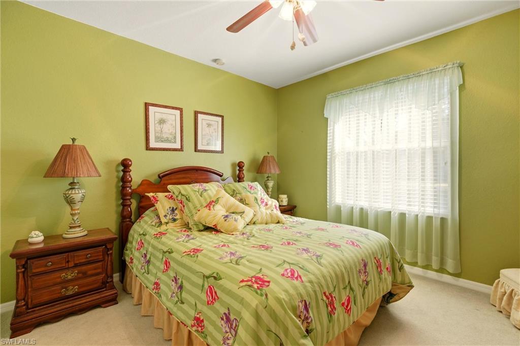 Bedroom with a ceiling fan and carpet flooring