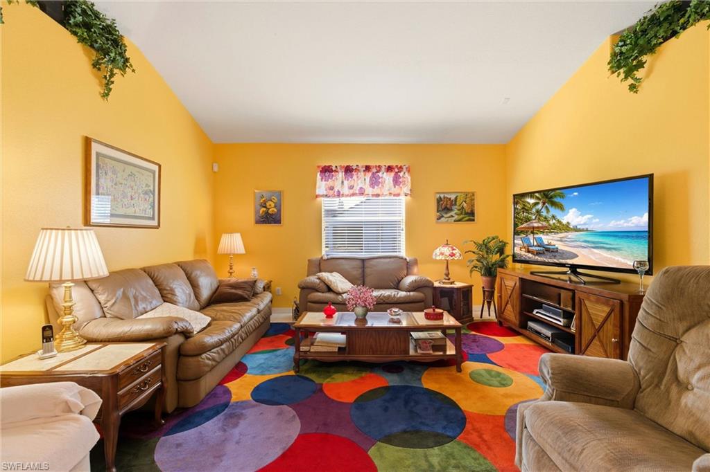 Living room with vaulted ceiling and carpet