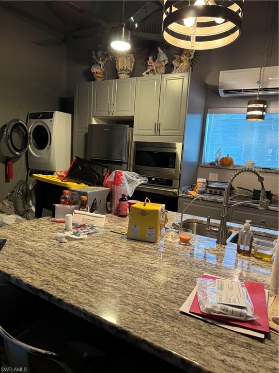 Kitchen featuring light stone counters, open floor plan.