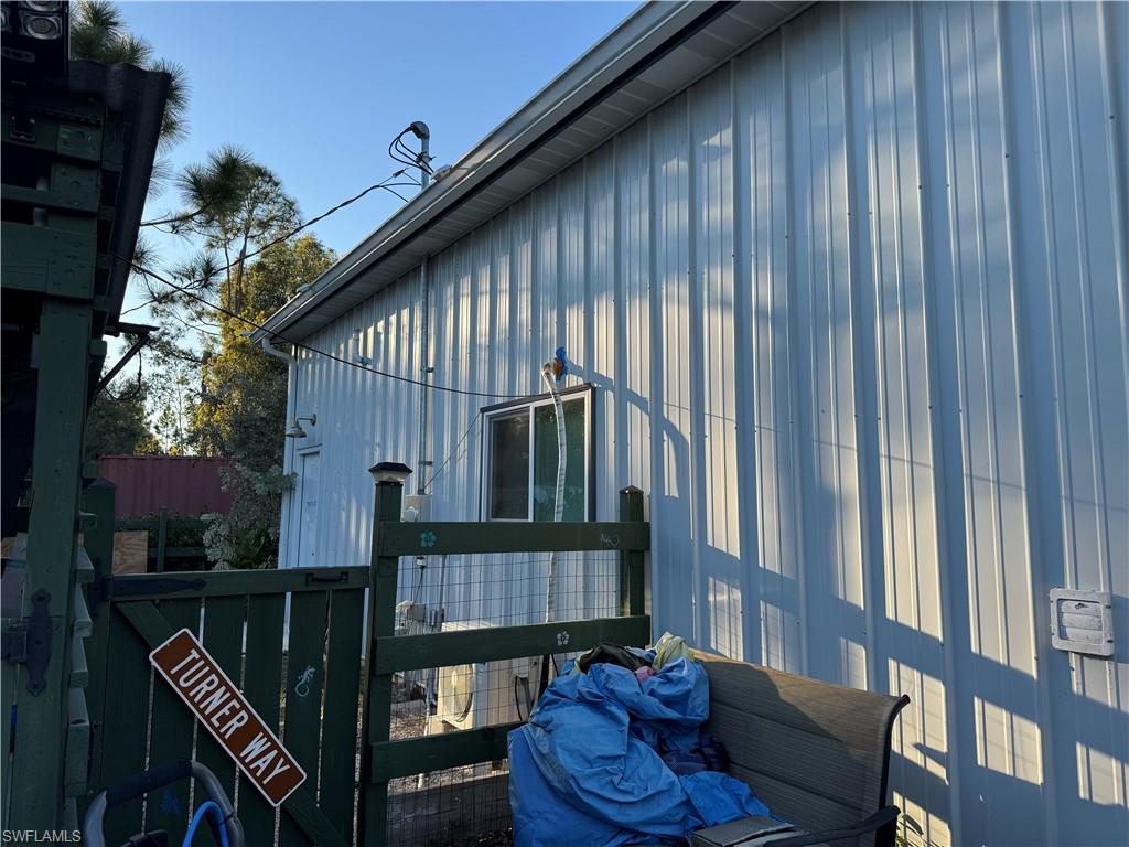 View of side of property with a gate
