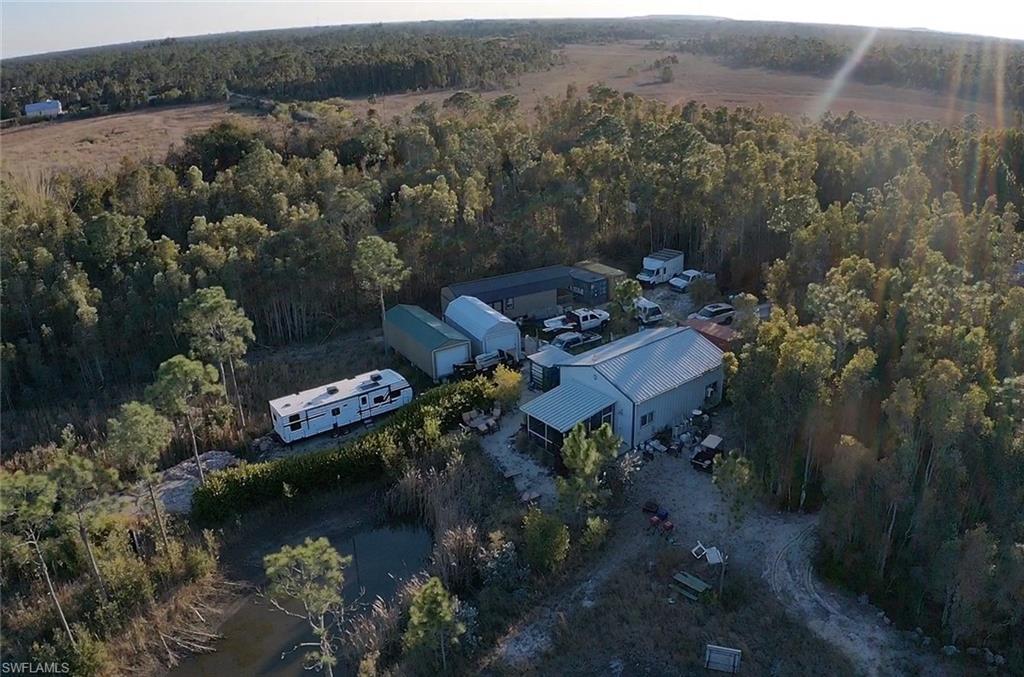 View of property location with a heavily wooded area