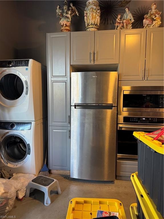 Kitchen with fridge, wall oven, stainless steel microwave, stacked washer and clothes dryer, and vinyl floors.