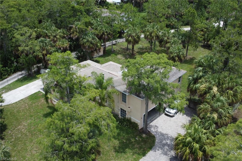 Two-story residence with a light-toned exterior and a multi-pitch roofline