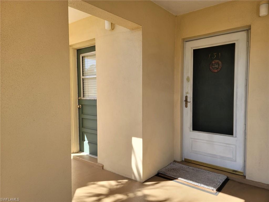 Doorway to property with stucco siding