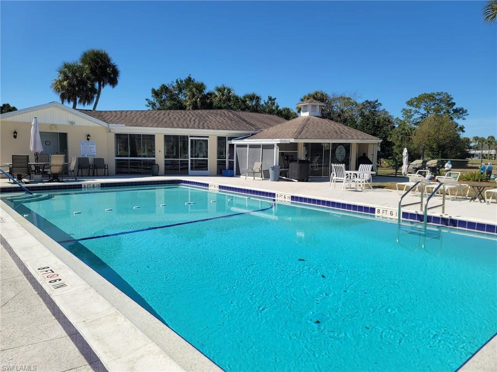 Community pool with a patio