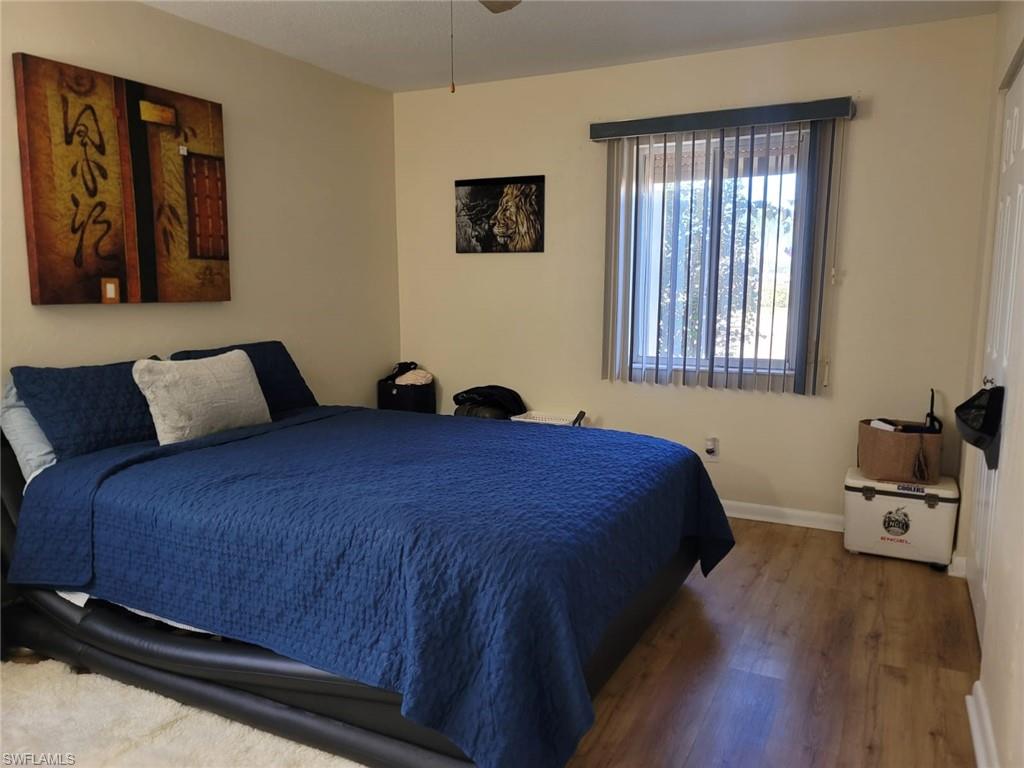Bedroom featuring wood finished floors and baseboards