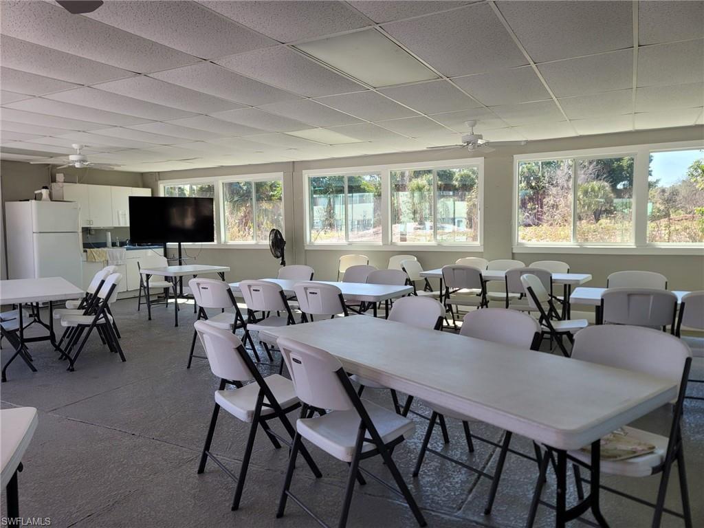 Dining room with a ceiling fan and a drop ceiling