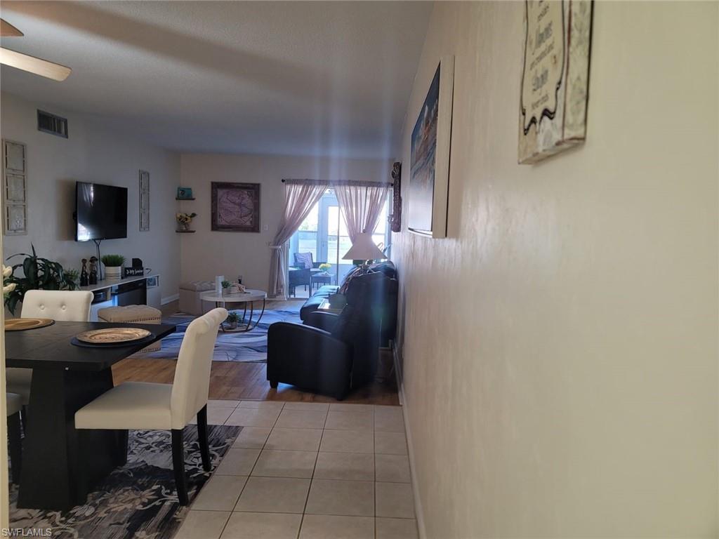 Dining area featuring light tile patterned floors and a ceiling fan