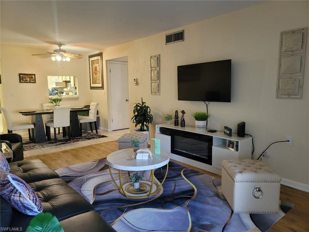 Living area featuring wood finished floors and a ceiling fan