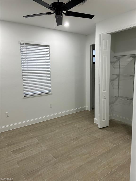Unfurnished bedroom featuring ceiling fan, light hardwood / wood-style flooring, and a closet
