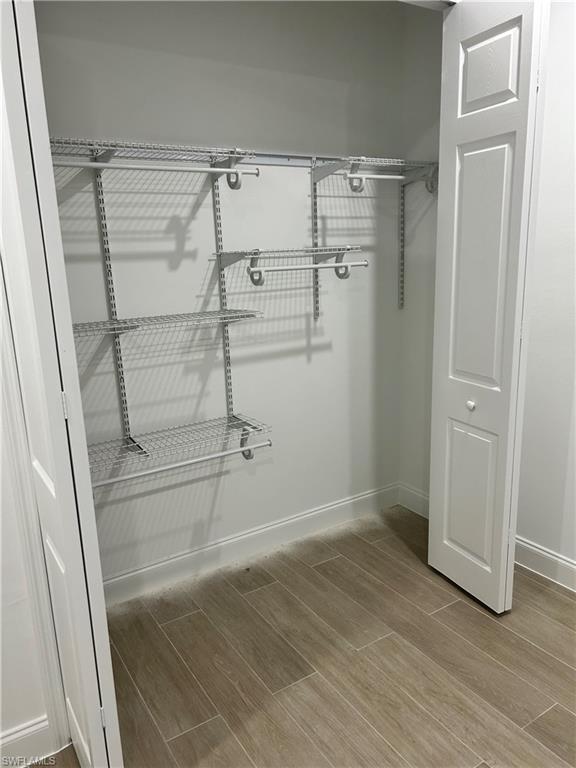 Walk in closet featuring wood-type flooring