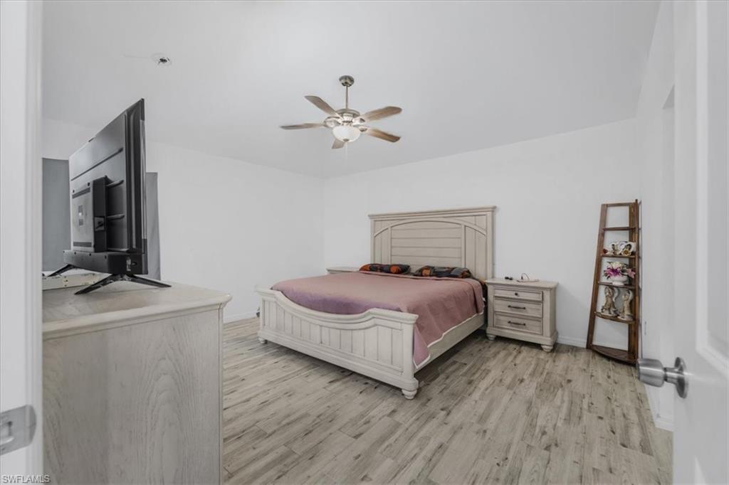 Bedroom featuring light wood finished floors and a ceiling fan