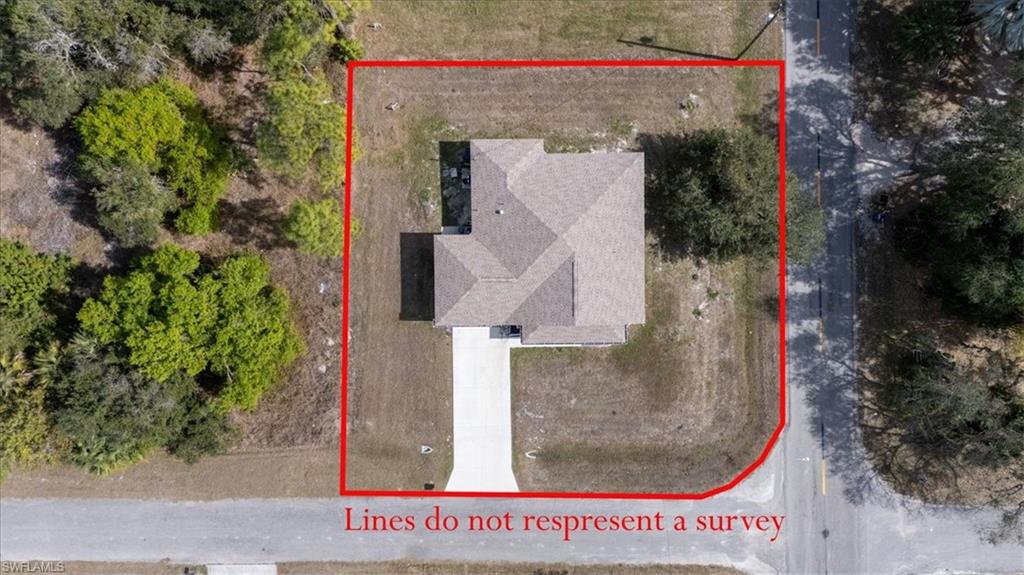 Aerial view of property and surrounding area featuring property parcel outlined