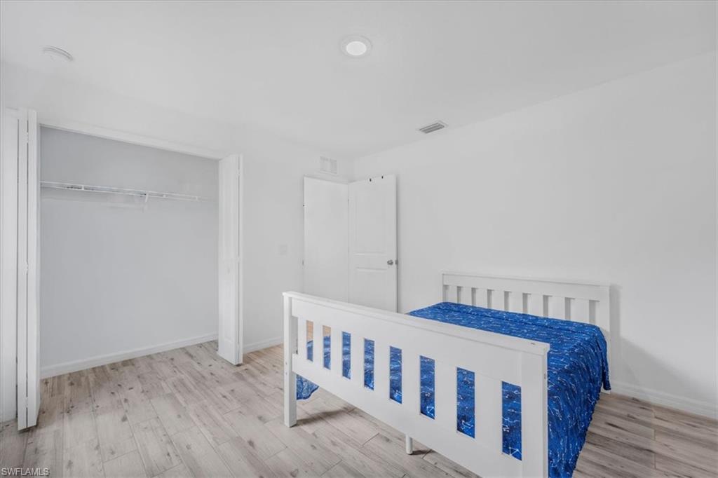 Bedroom featuring light wood-style floors and a closet