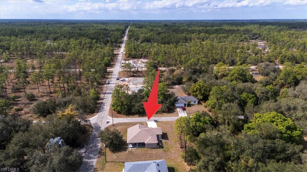 Aerial view of property's location featuring a heavily wooded area