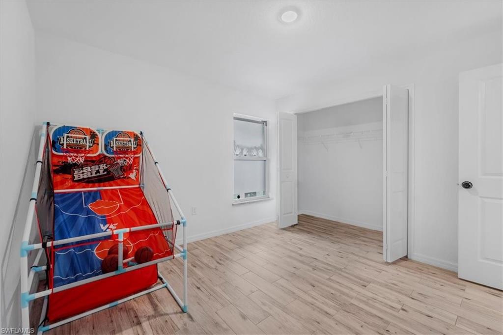 Bedroom with light wood-type flooring and a closet