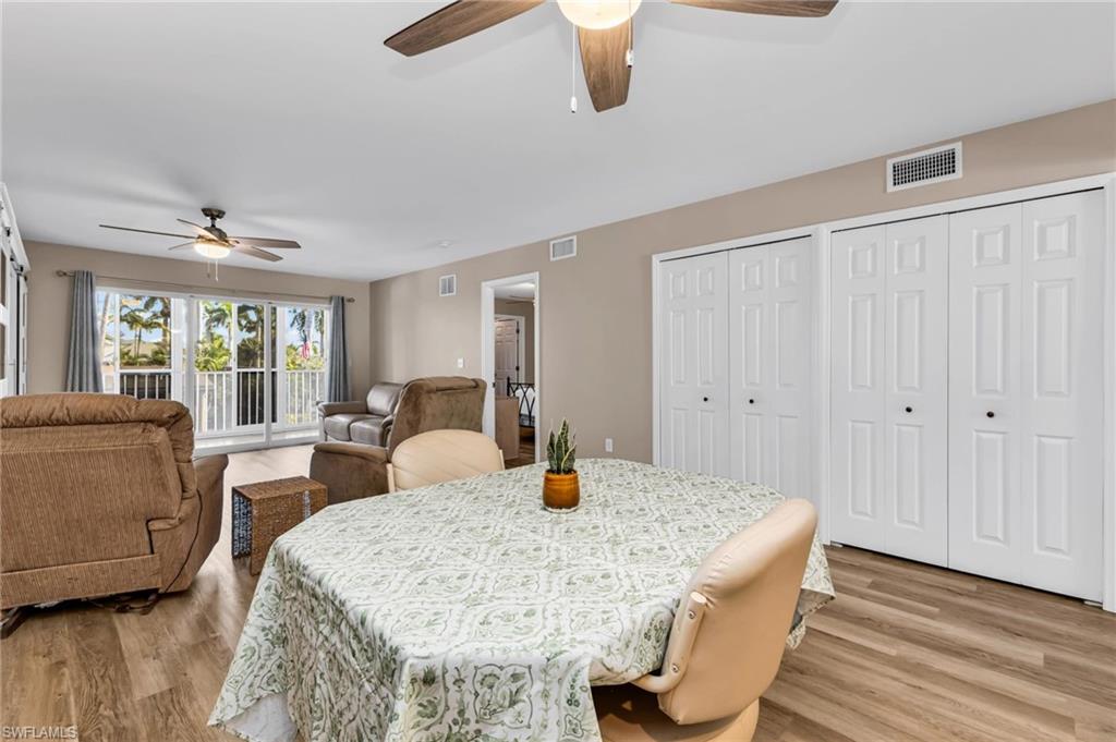 Dining area with light wood-style flooring and a ceiling fan