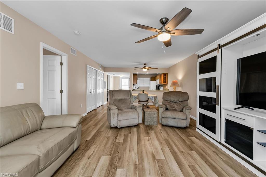 Living area featuring light wood-style floors and a ceiling fan