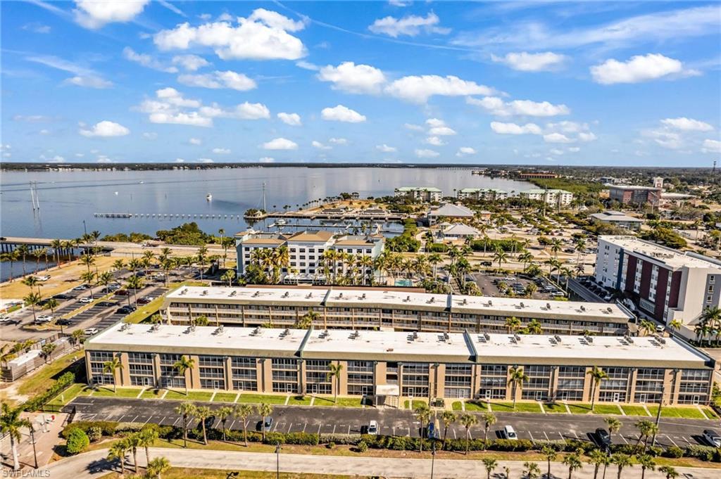 Drone / aerial view of apartment complex / building and a nearby body of water