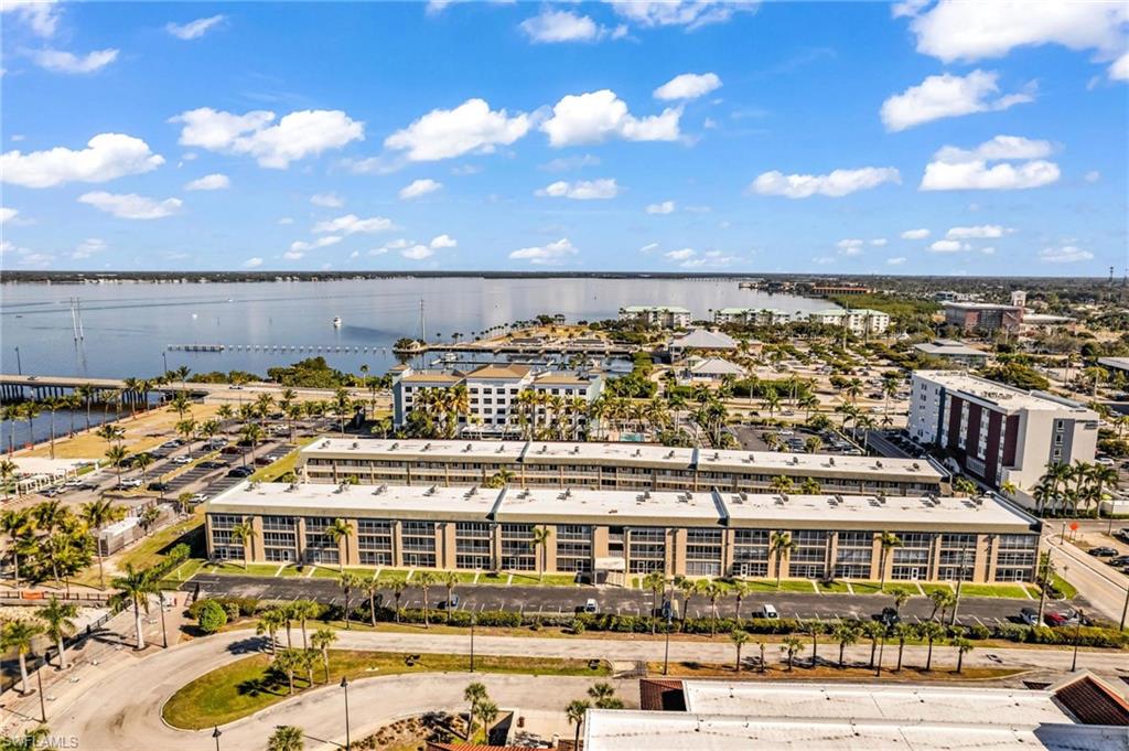 Bird's eye view of a nearby body of water and apartment complex / building