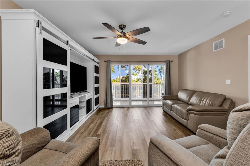 Living area featuring light wood-type flooring and a ceiling fan