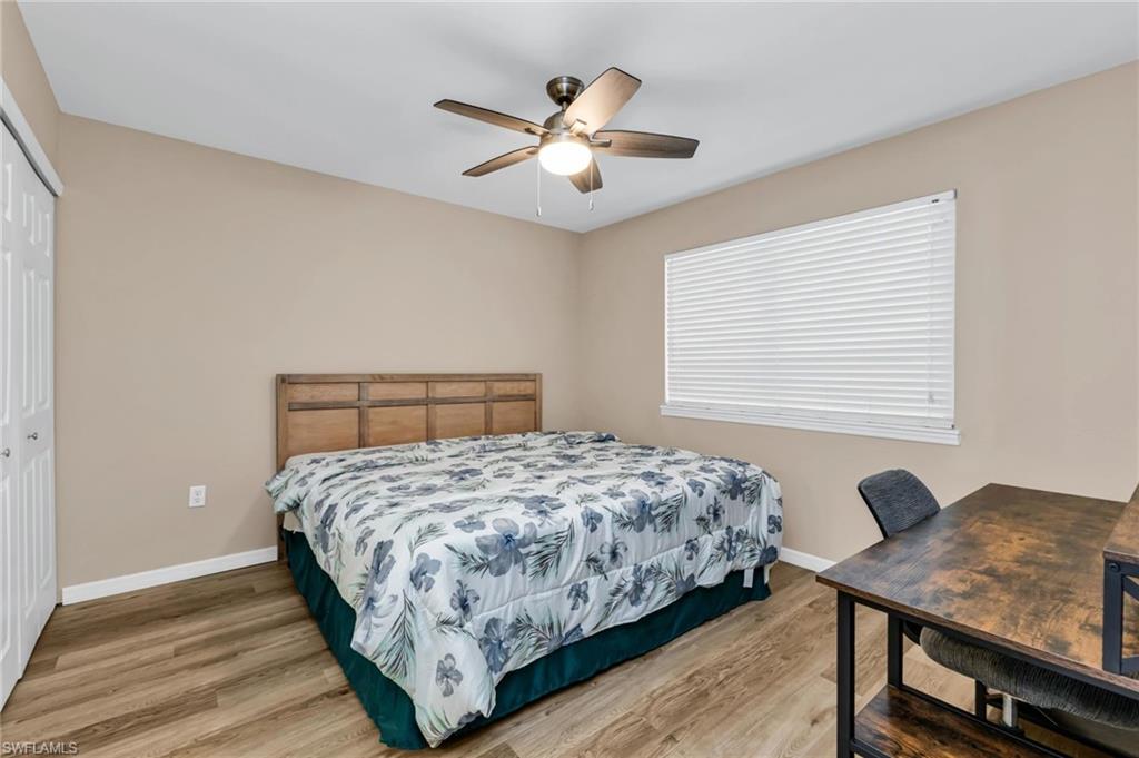 Bedroom with a closet, light wood-style floors, and a ceiling fan
