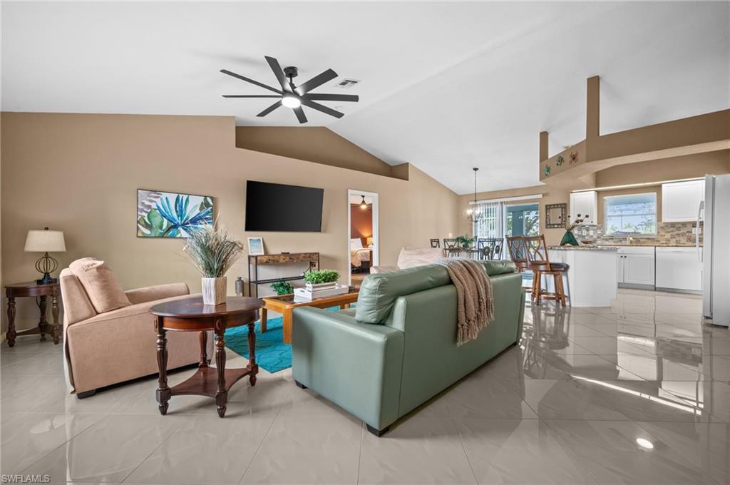 Living room with vaulted ceiling and ceiling fan