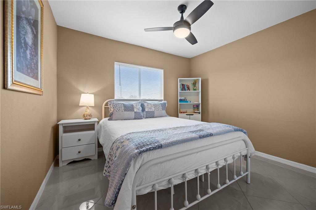 Bedroom featuring baseboards and ceiling fan