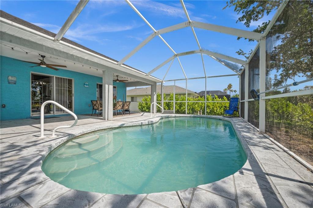 Swimming pool with a lanai, a sunroom, a patio, and outdoor dining space