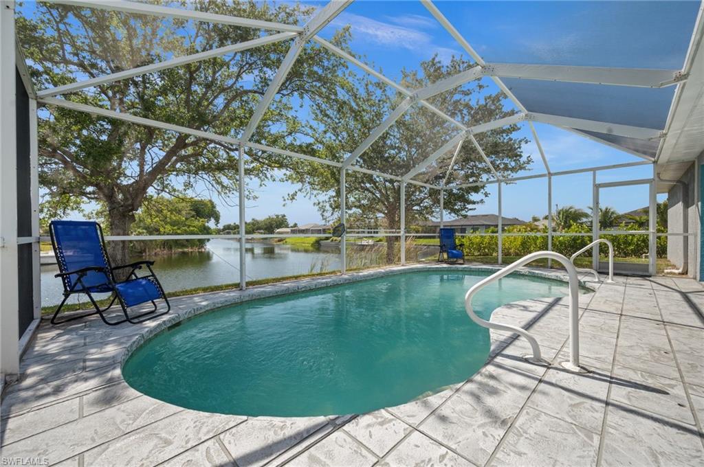 Outdoor pool featuring a lanai, a sunroom, a patio area, and a water view